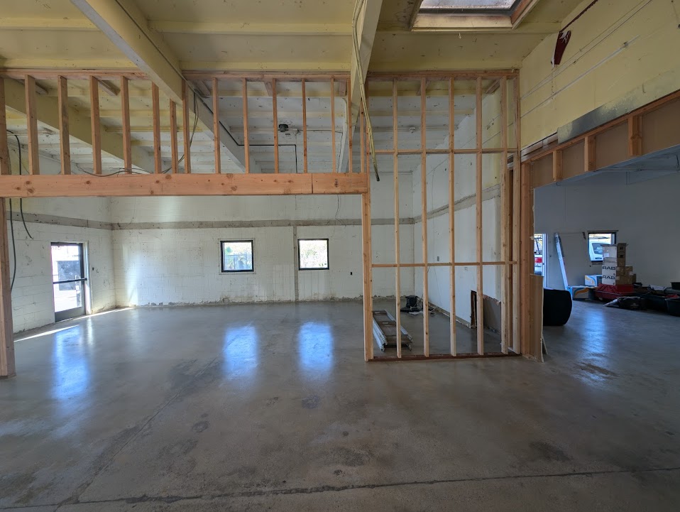 Commercial mezzanine framing structure with natural light in industrial space