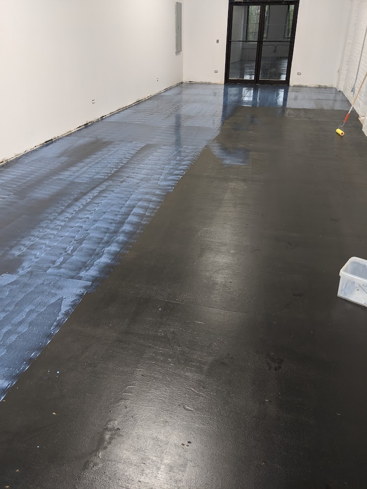 Specialty polyurethane floor top coat being applied in commercial unit