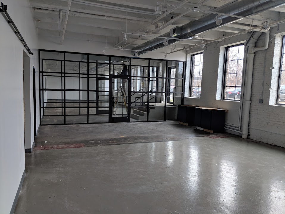 Full-height steel and glass partition wall in commercial lobby