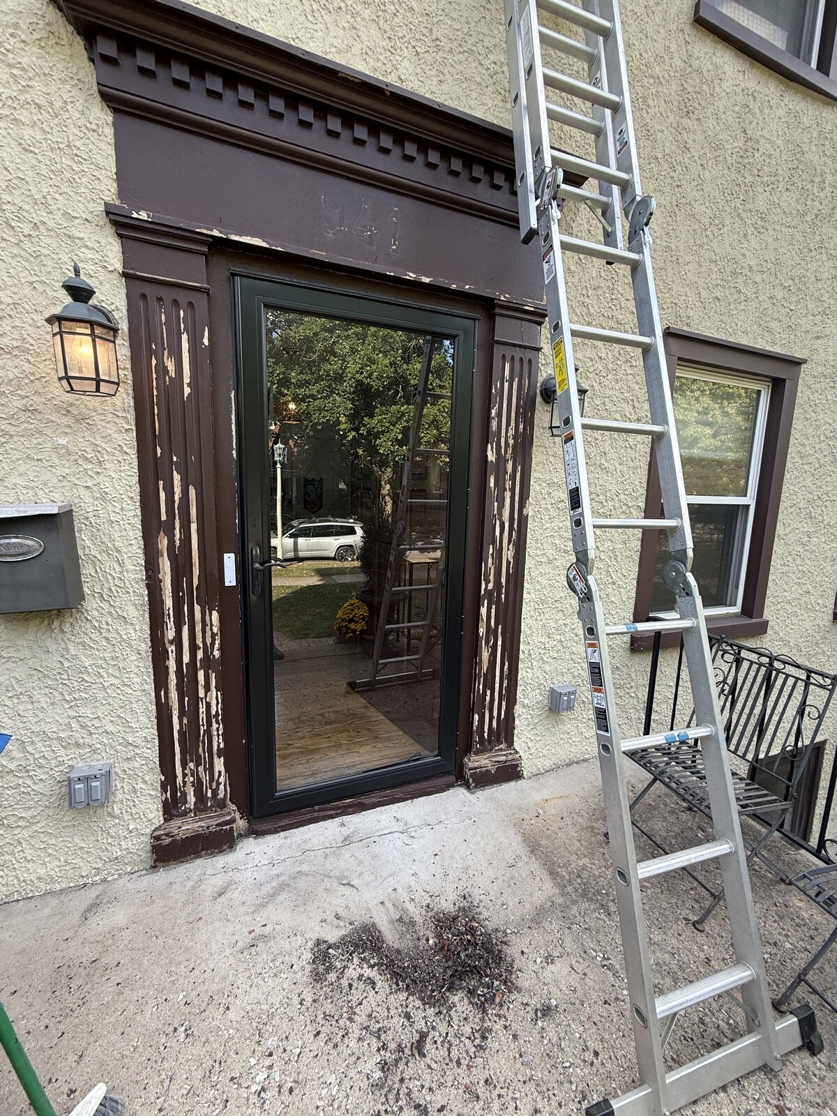 Front entrance door surround with peeling paint before restoration